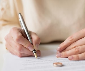 Woman signing a divorce contract