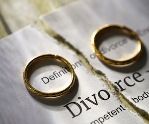 Two rings over a ripped paper