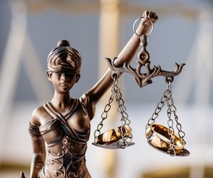 scales of justice with two rings