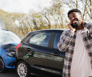 Man on phone after a car crash