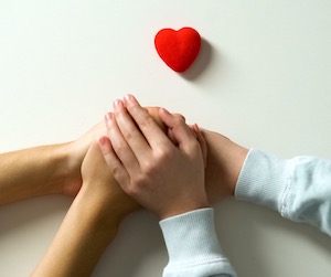 Hands holding a toy house