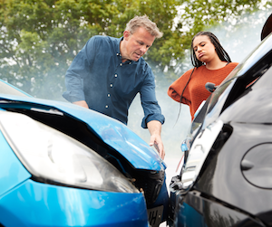 Two persons watching a car crash